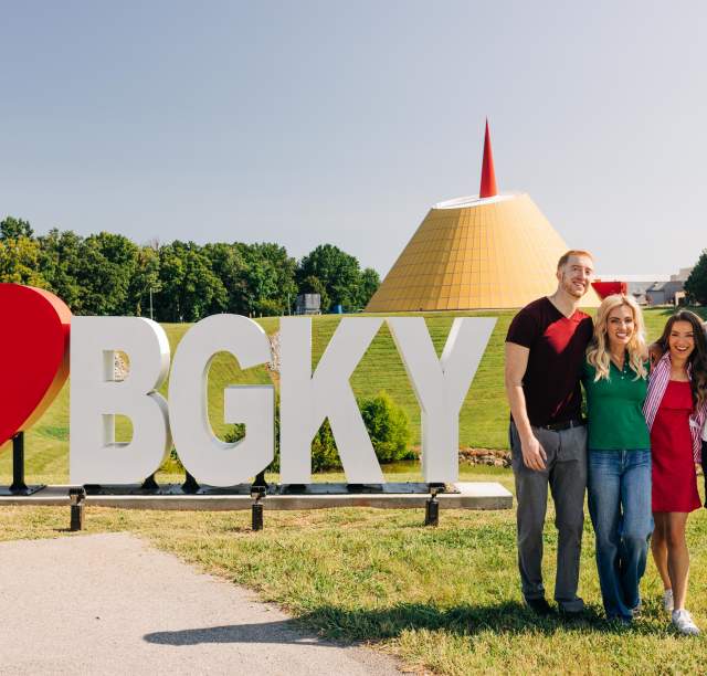 Group of friends posing in front of a sign that reads, "HeartBGKY." Located in front of the National Corvette Museum in Bowling Green, Kentucky.