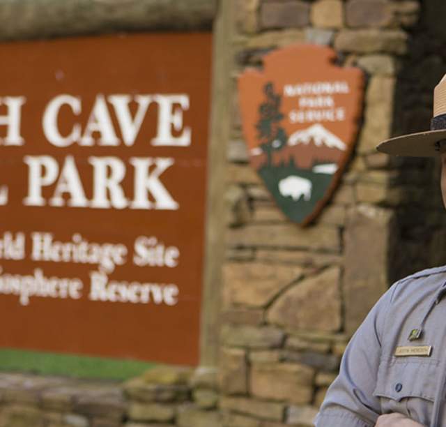 Ranger in Front of Mammoth Cave National Park Sign In Bowling Green, KY