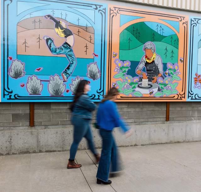 People walking in front of artwork outside of the Rotary Centre for the Arts