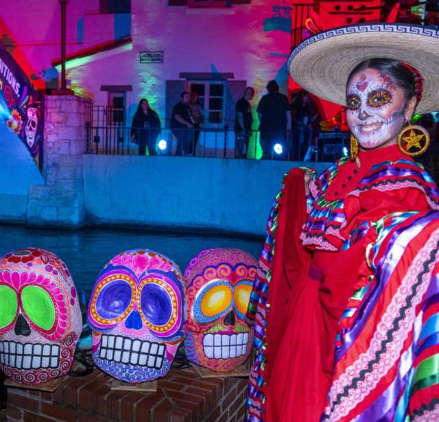 Woman dressed in pancho with sugar skull face painting