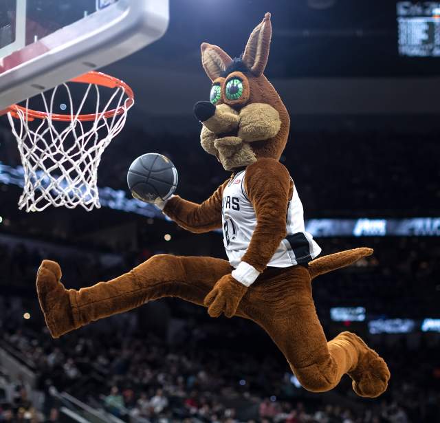 San Antonio Spurs Coyote slam dunking basketball at Spurs game