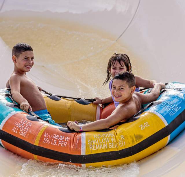 Three kids on inner tube ride
