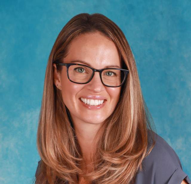 Woman in front of blue background.