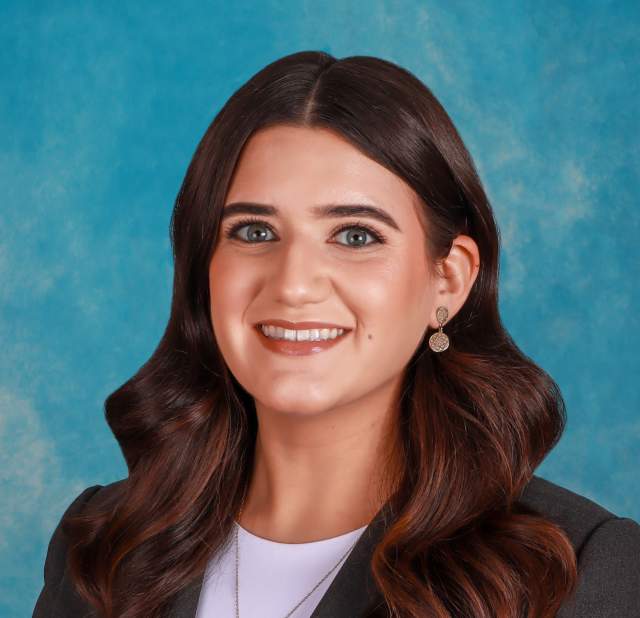 Woman in front of blue background.
