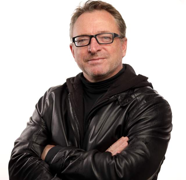 Mark Duval smiling and posing for a headshot.