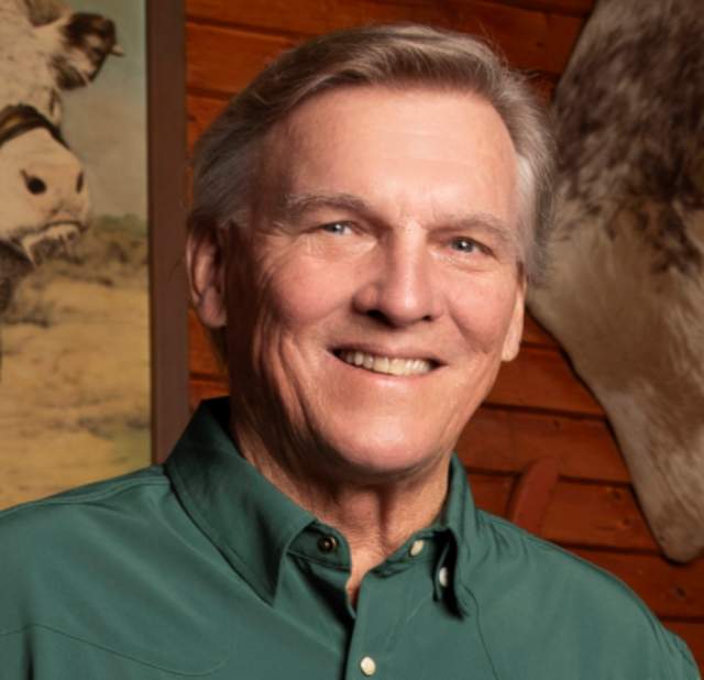 Skeeter Miller smiling into the camera posing for a headshot.