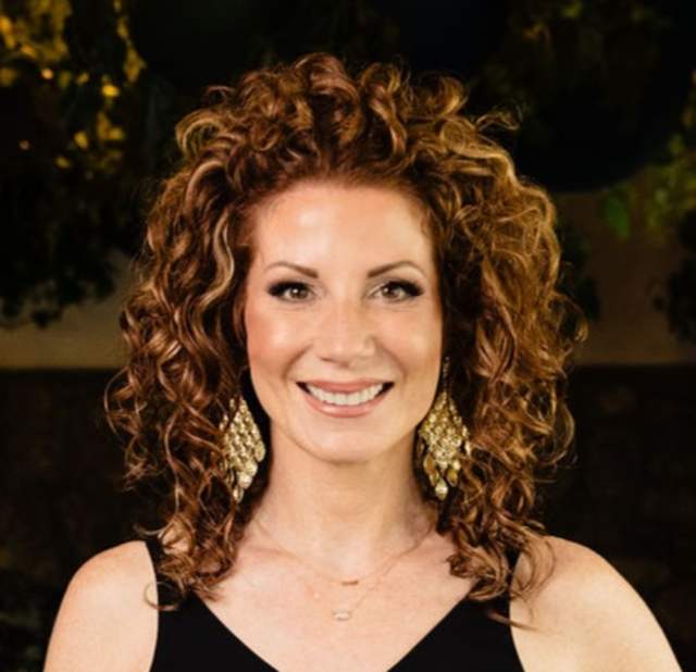 Tacy Infante posing for a headshot.
