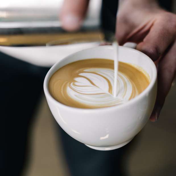 Pouring cream design in coffee