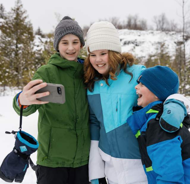 Siblings stop snowshoeing to take a selfie