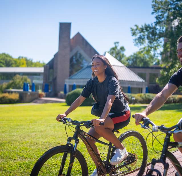 Two people ride bikes at Windrose on Hudson.