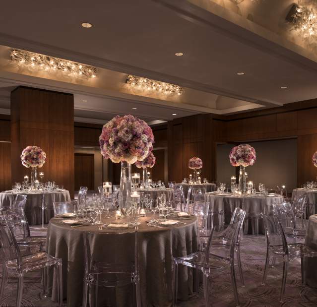 The Opus ballroom with tables and floral arrangements.