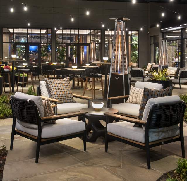 A grouping of plush seats on an outdoor patio.