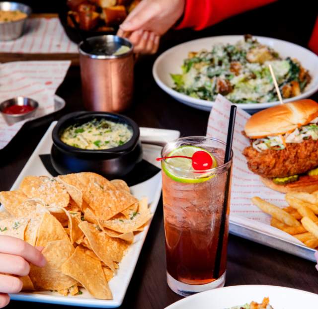 A table with plates of food from Red Door Woodfired Grill.