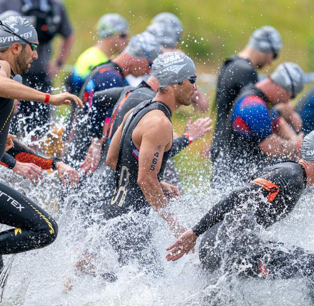 Athletes entering the water for the USA Triathlon event.