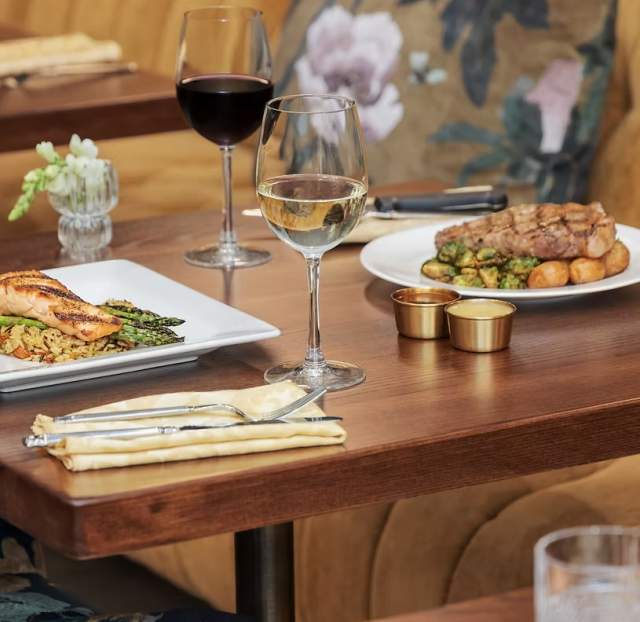 A table with plates of food from Gilded Feather.
