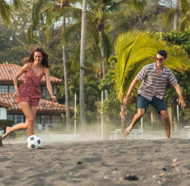Friends having fun and playing with a ball on Cambutal beach