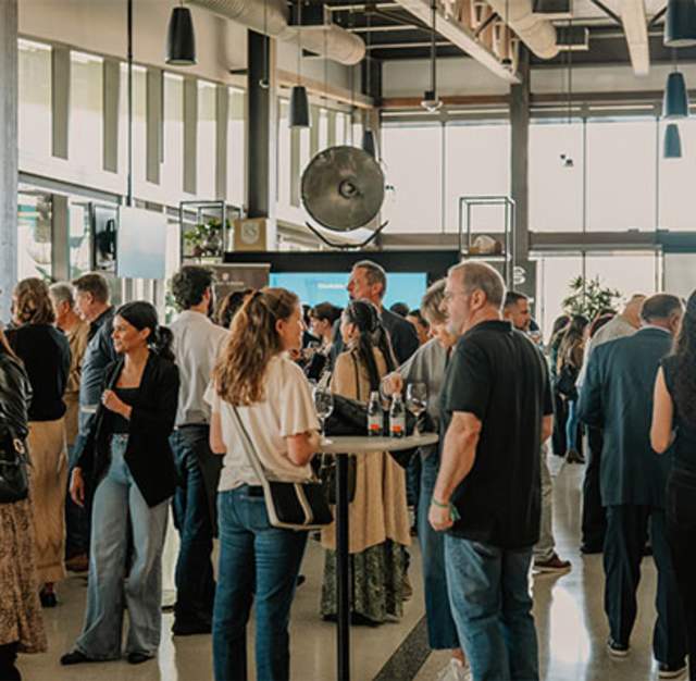 People mingling at Flavors of the Peninsula 2026 Camber Event.