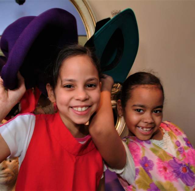 Two young girls playing dress-up at Fayetteville's Fascinate-U Children's Museum