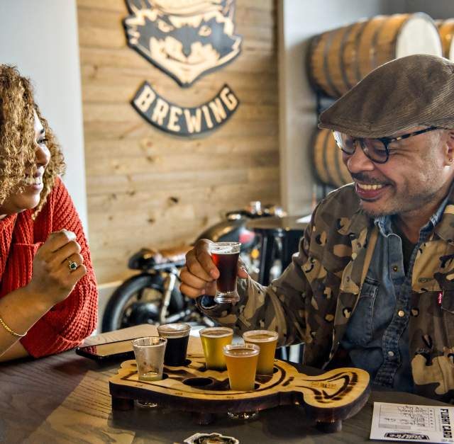 Couple at the brewery table with beer tasting