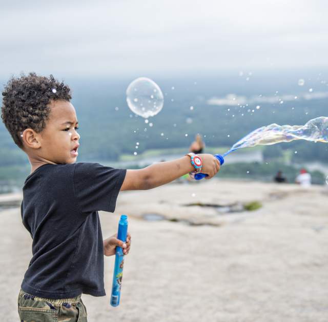 Kid playing with bubbles