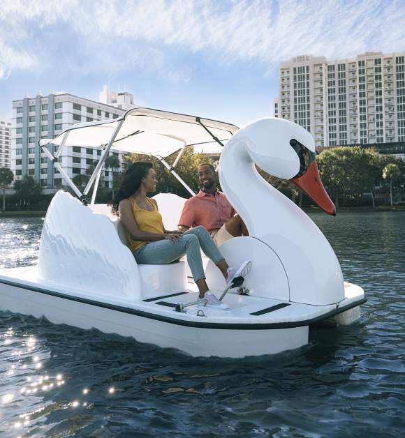 Couple exploring Lake Eola on a swan boat, Do not use - For use only on new Website