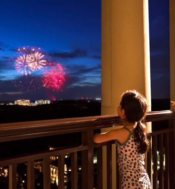 Four Seasons Resort Orlando at Walt Disney World® Resort children watching fireworks from balcony