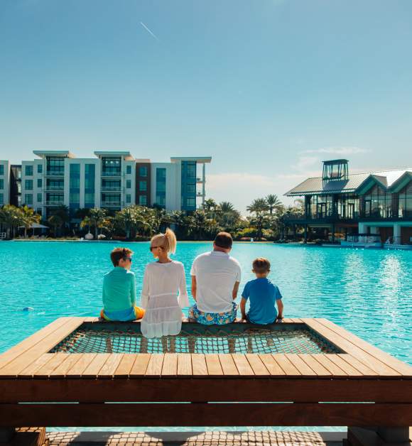 Family Sitting on Overwater Hammock in Bayside Cabana