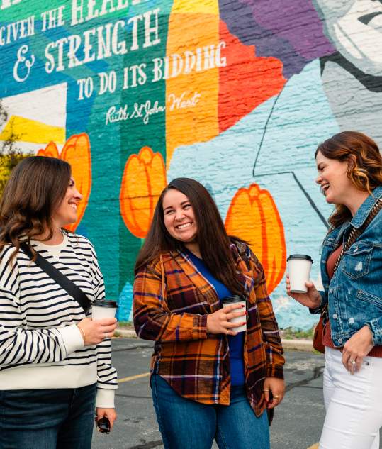 women in front of Ruth West mural in downtown Manitowoc Wisconsin