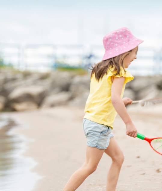 Girl Playing at Lighthouse Park Beach in Manitowoc
