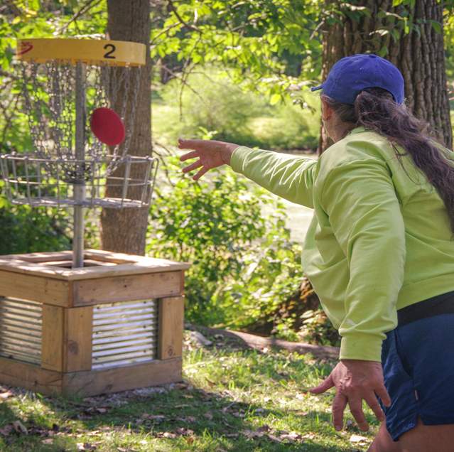 Woman playing disc golf in Northwest Indiana