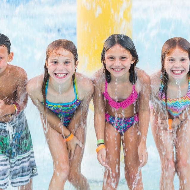 Kids smiling at Deep River Waterpark's splash pad