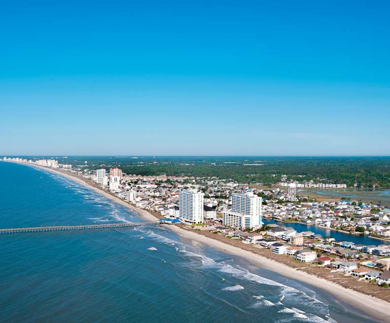 an aerial shot of North Myrtle Beach during a sunny day, featuring the Cherry Grove Pier