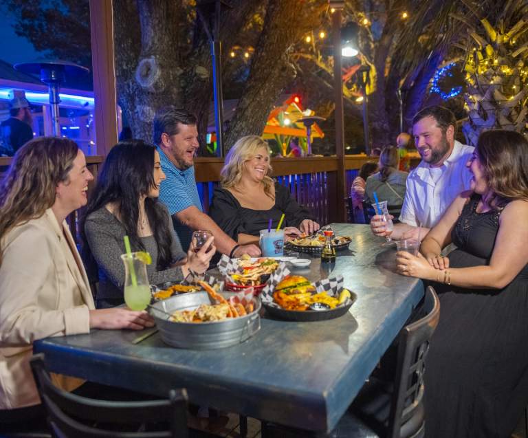 A group of friends dines outdoors at Boardwalk Billy's