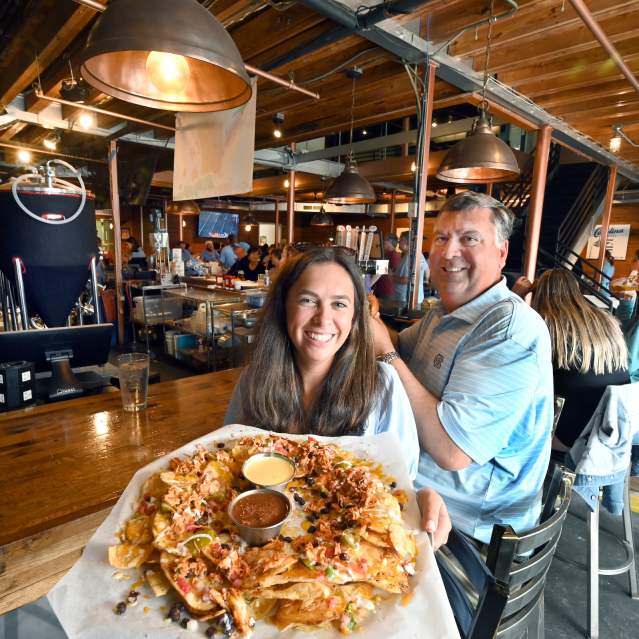 Person holding out an appetizer tray at the Carolina Brewery