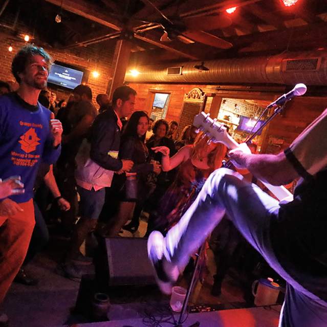 People watching a band playing live on stage