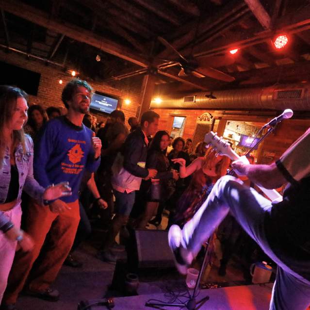 People watching a band playing live on stage