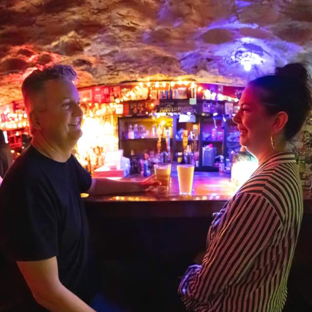 People sitting at the bar at the nightclub, The Cave