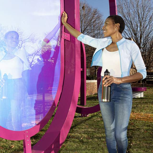 Person seeing their reflection in the pARC art installation at the Ackland Art Museum
