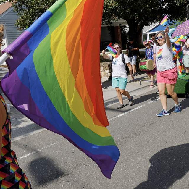 People walking in the Pride Parade in Chapel Hill and Carrboro