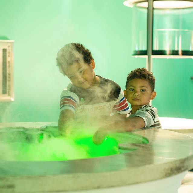 Two boys enjoying science center exhibit