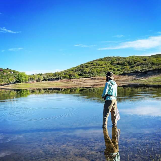 Fisherman fly fishes in one of the lakes on the Grand Mesa