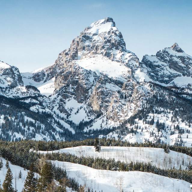 Grand Tetons with snow and blue skies