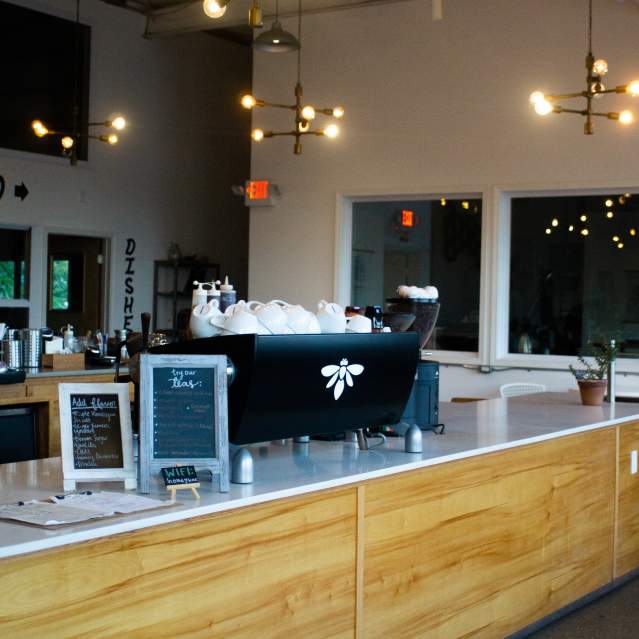 Open ceilings and drop lighting give the interior of Knoxville's Honeybee Coffee Co an industrial yet inviting vibe.