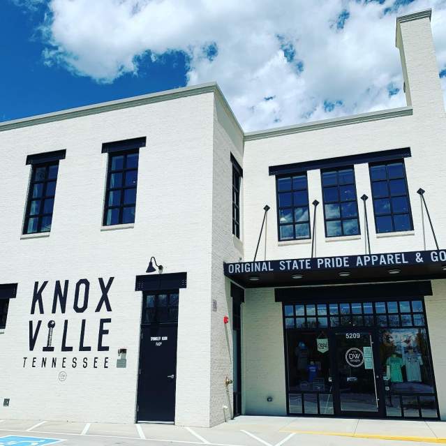 The white exterior of the Knoxville apparel and branded goods store shines bright in the summer sun.