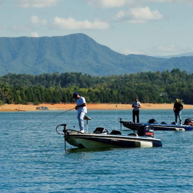 Men fishing on boats at Douglas Lake in Knoxville, TN