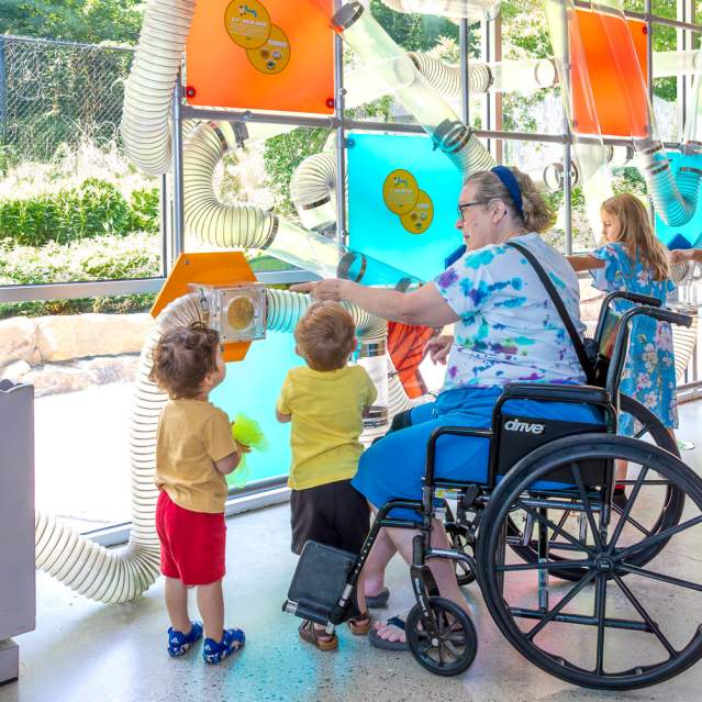 Woman in wheelchair with young children at Muse Knoxville
