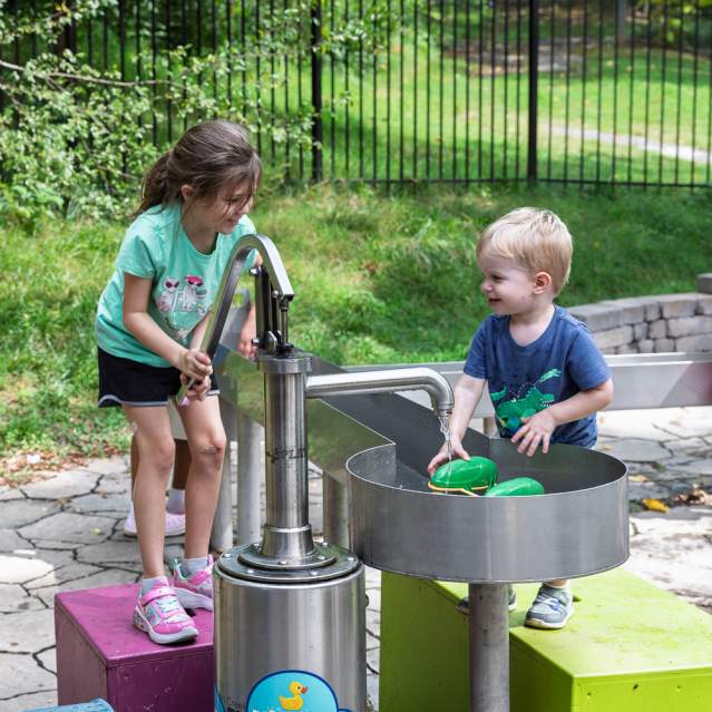Two young children playing outdoors at Muse Knoxville