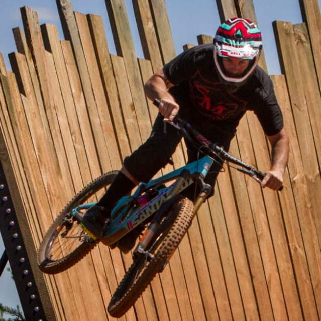 A mountain biker launches off the wall ride on the Devil's Racetrack at Baker Creek Preserve in Knoxville. .