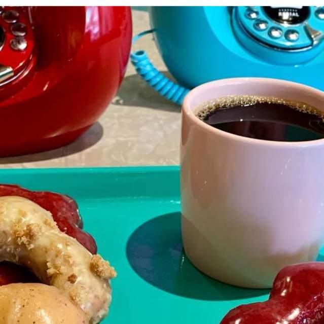 Coffee and a couple donuts on a tray