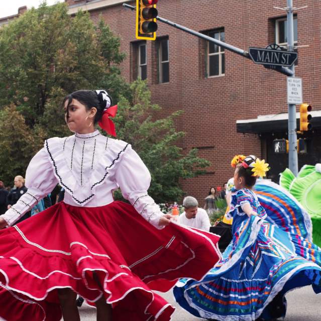 Young women dancing during Day of the Dead parade